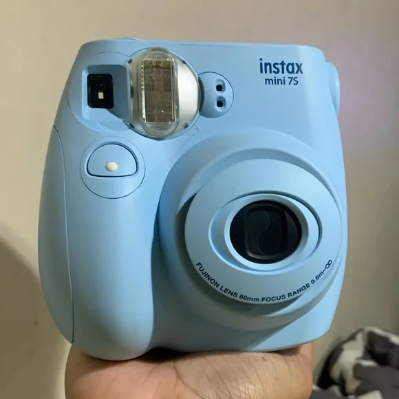 Light blue Polaroid camera and matching photo book to them the memories in.